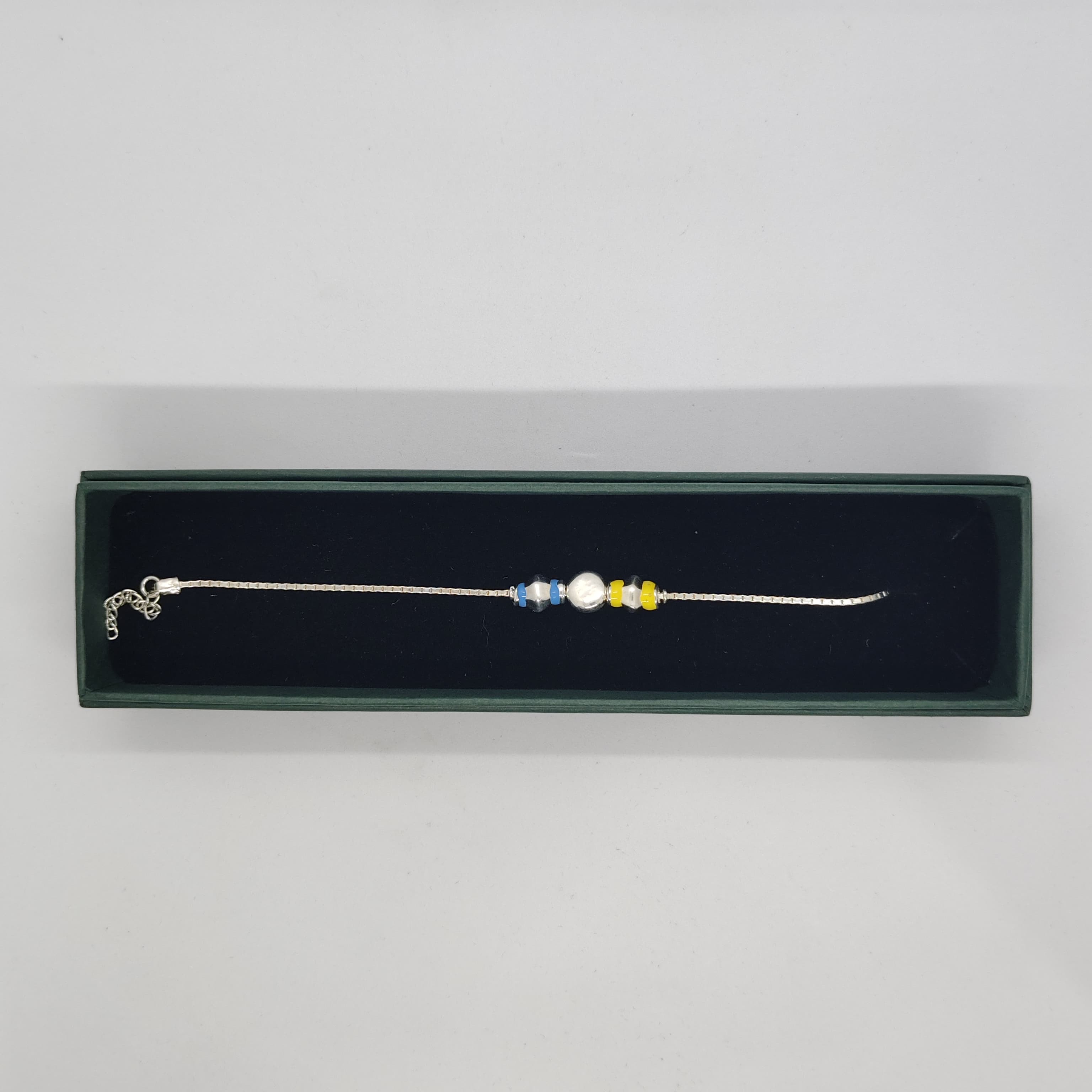 Silver Rakhi with Yellow and Blue Beads - Silver Rakhi