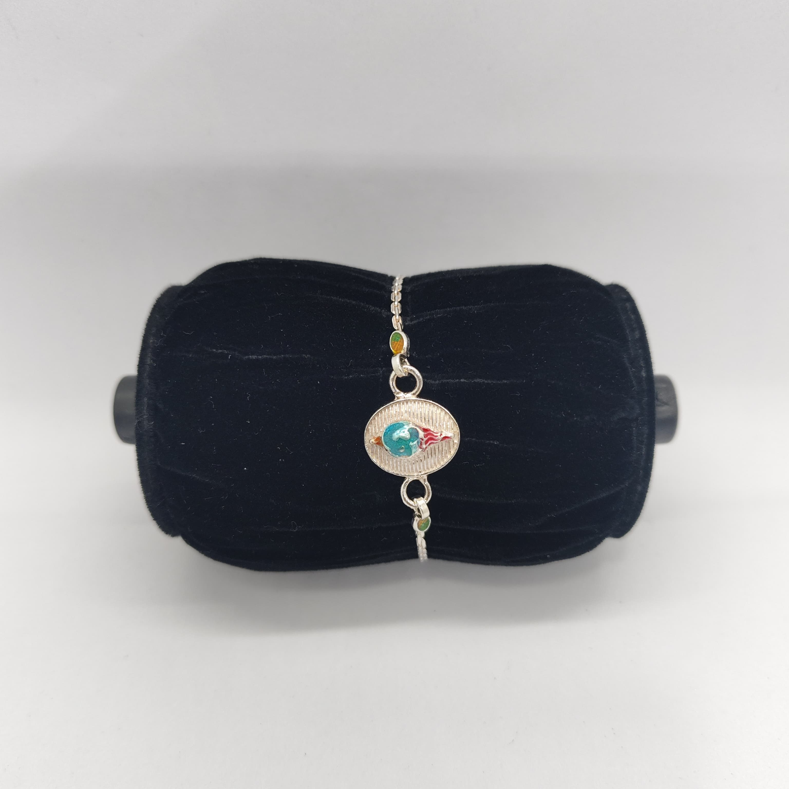 Silver Rakhi with Blue and Red Oval Work - Silver Rakhi
